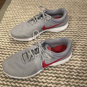 Nike men’s tennis shoes. Like new condition. Size 12W. Gray with red check